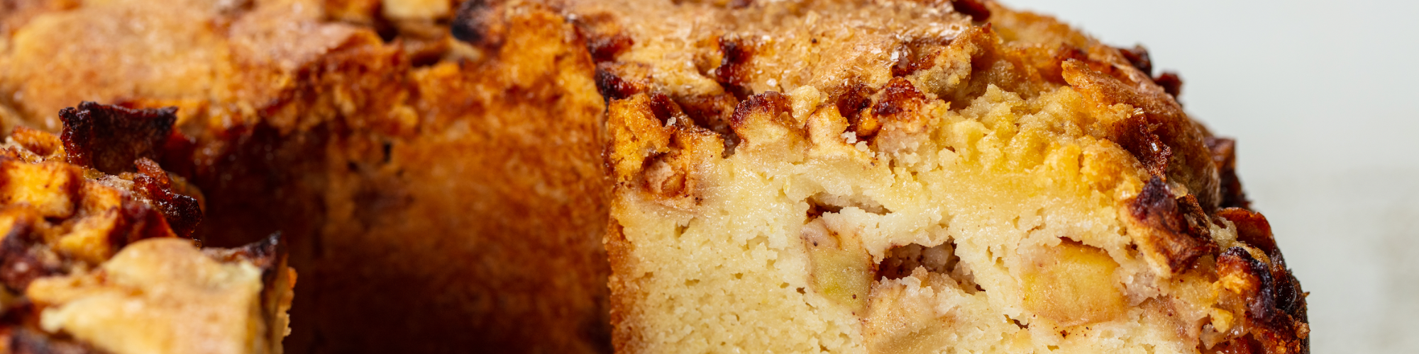 dairy free apple cake made with domino sugar next to bowl of apples